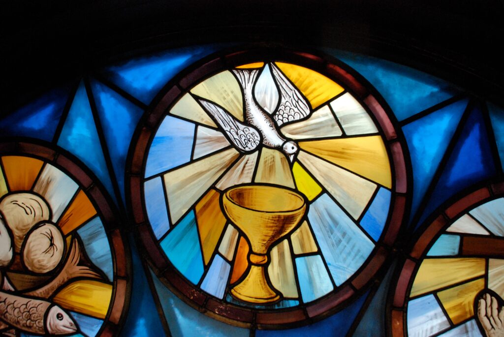 Stained glass window with dove and the Eucharist photo
