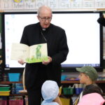 Bishop Read Wonky Donky To The Class After Mass photo