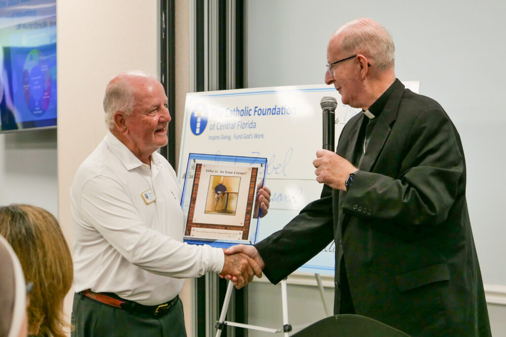 Kevin Bowler shakes hands with Bishop Noonan